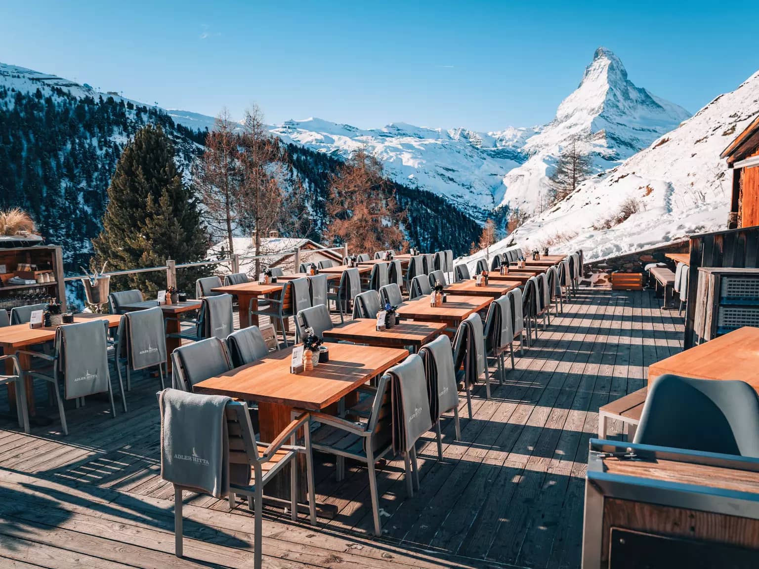 Restaurant Adler Hitta outdoor wooden terrace dining with Matterhorn mountain view in Zermatt, Switzerland