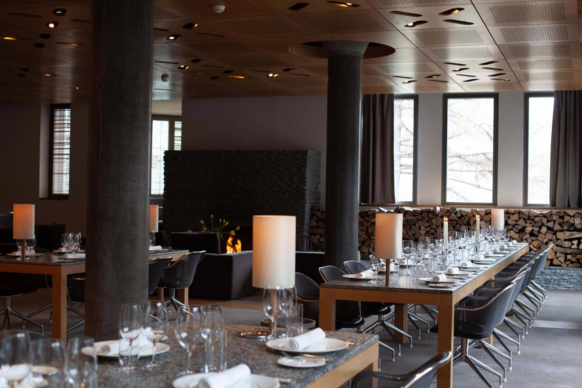 Modern hotel restaurant interior with set dining tables and fireplace at The Omnia