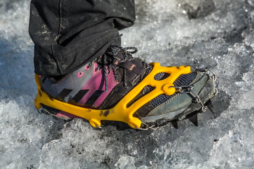Spikes to walk on glacier ice stuck to woman's foot.