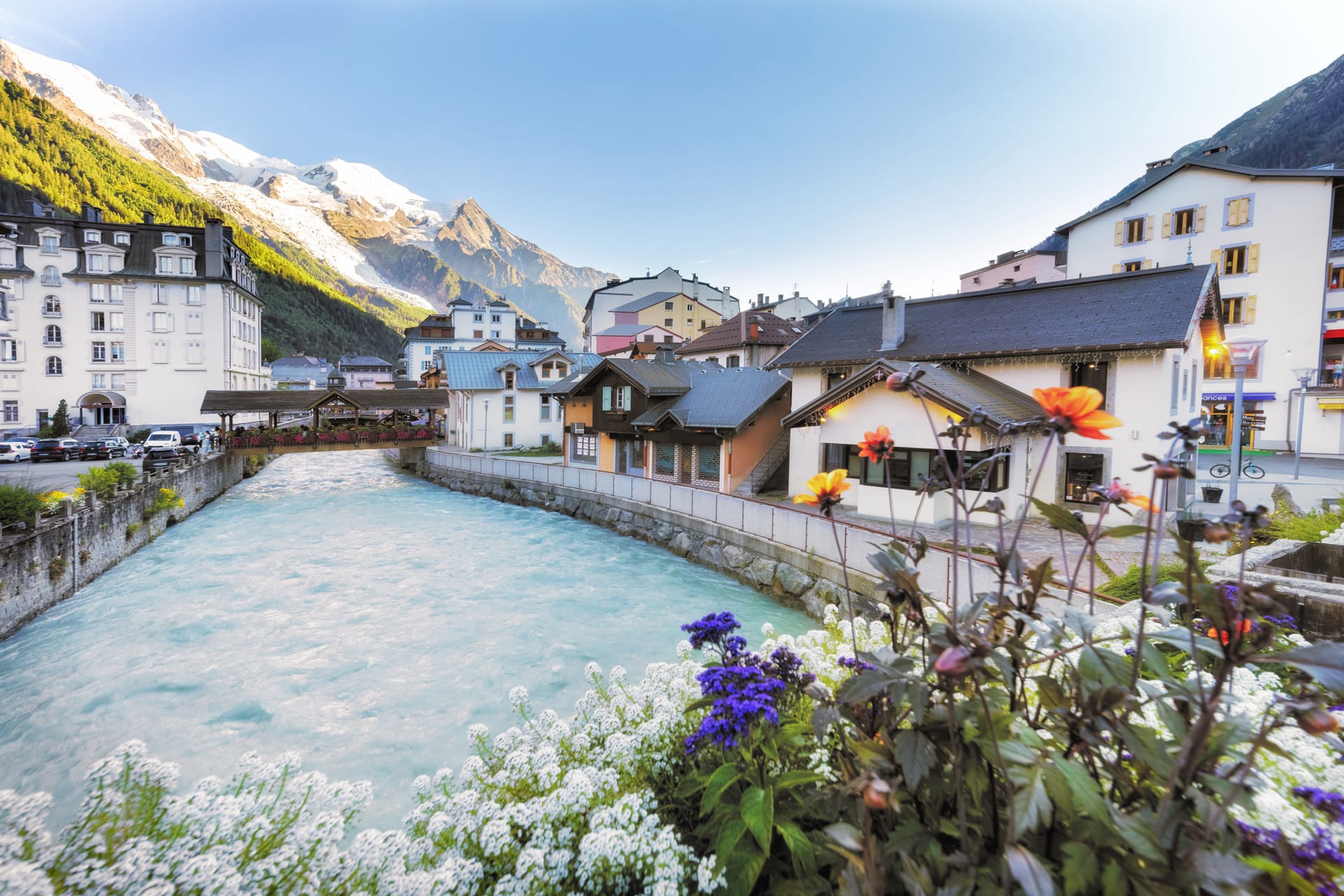 Chamonix alpine village with turquoise river and snow-capped mountains