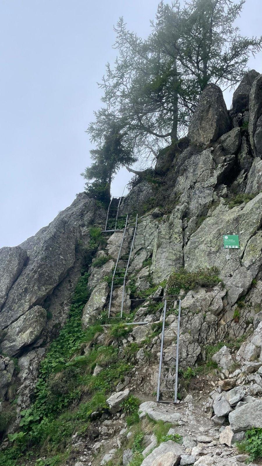 Metal ladders on a rocky alpine mountain cliff at Lac Blanc