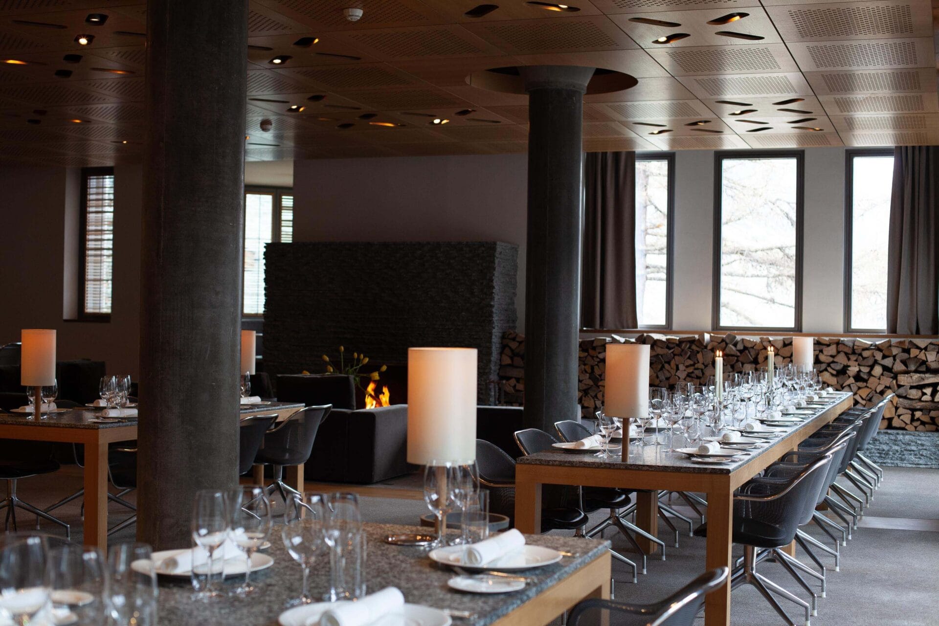 Modern hotel restaurant interior with set dining tables and fireplace at The Omnia