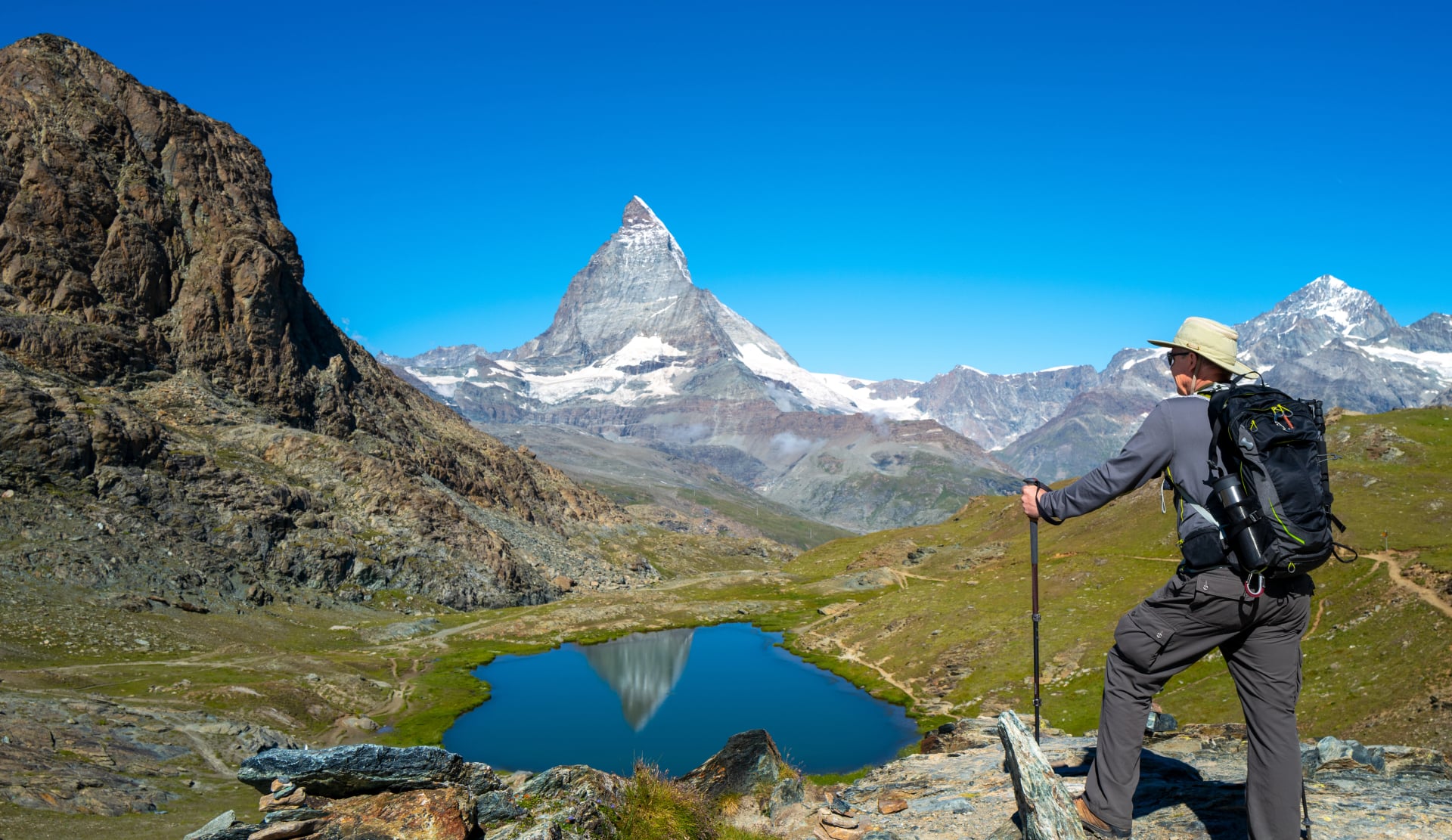 Senior man hiking the Swiss alps near the Matterhorn