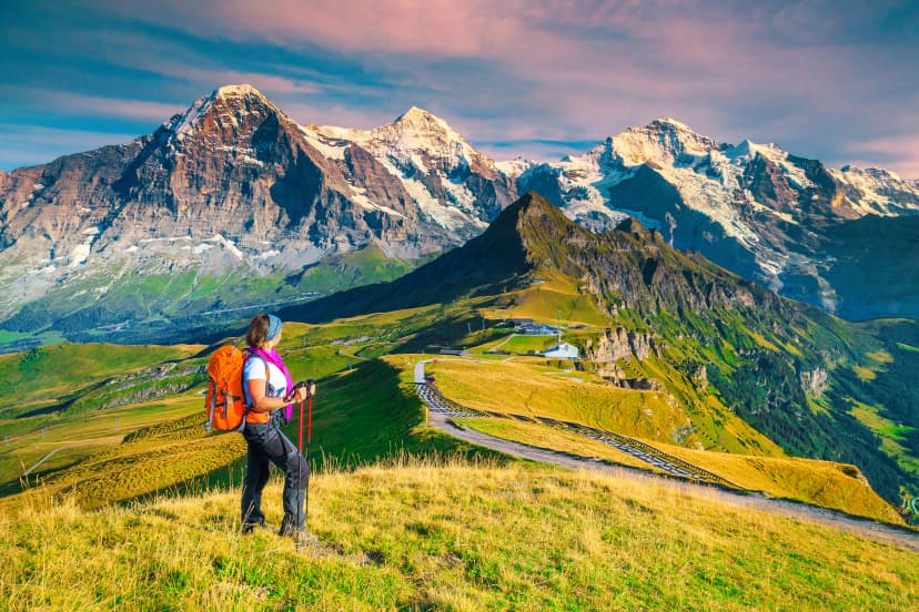 Mannlichen tourist station with backpacker hiker woman, Grindelwald, Switzerland, Europe