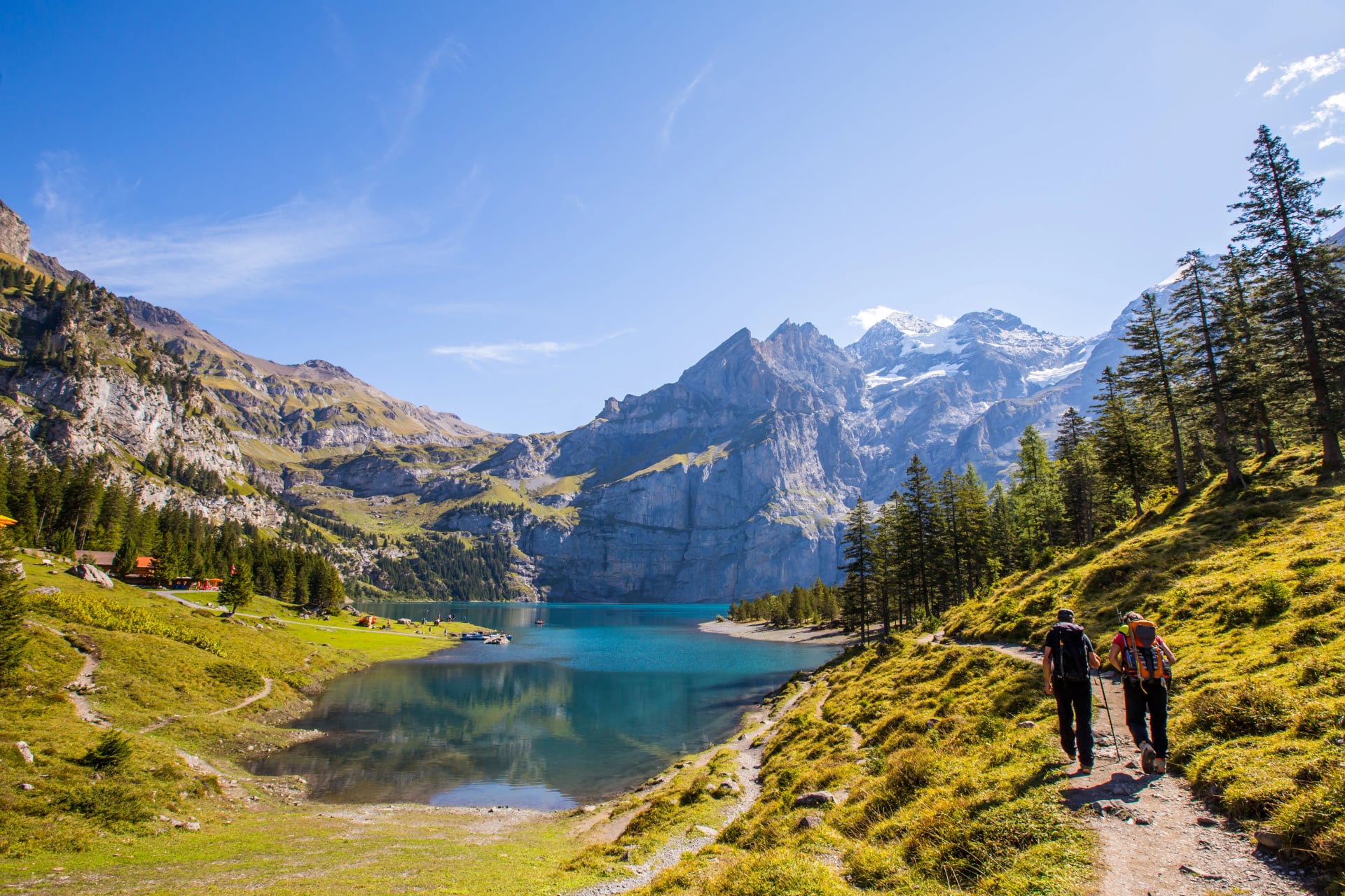 Tourist in summer view over the Oeschinensee (Oeschinen lake)