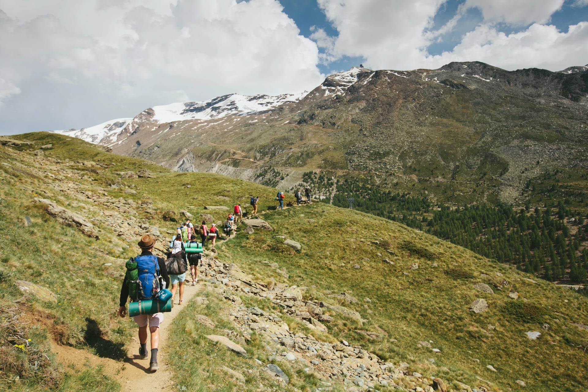 Matterhorn Mountain with white snow and blue sky in Zermatt city in Switzerland. People are hiking to the mountain