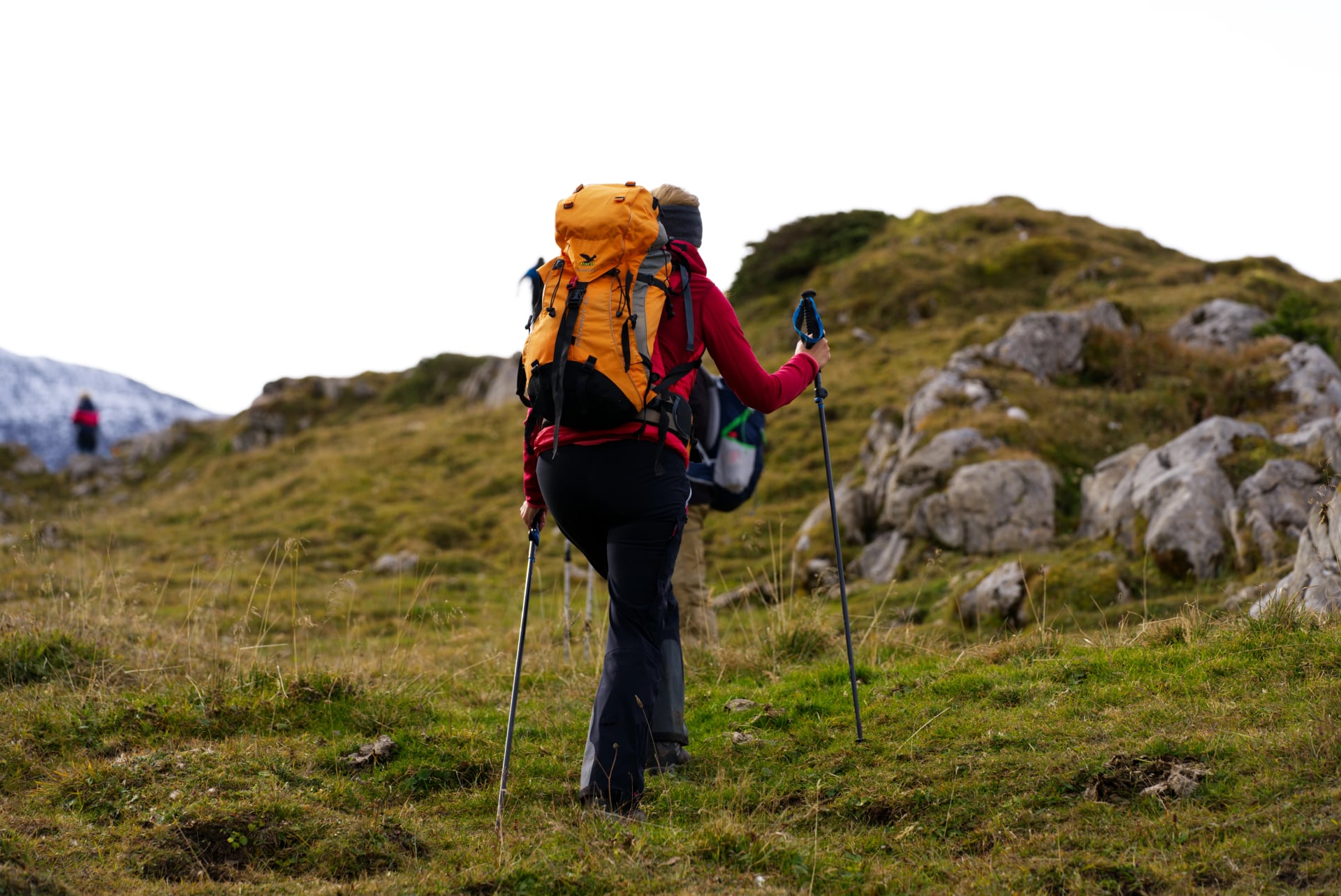Hiking group way up at Axalp Bernese Highlands on a grey cloudy day. Photo taken October 19th, 2021, Brienz, Switzerland.