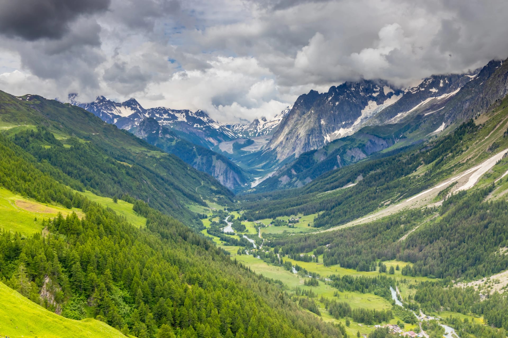 Beautiful mountain landscape of the Alps in summer on tour du Montblanc area near Courmayeur village in Val Ferret valley in Italy. European Alps stunning views of green valley with colorful flowers