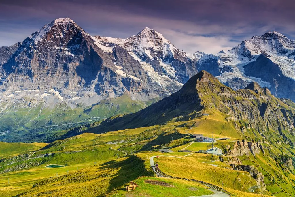 Stunning alpine panorama with Jungfrau Monch Eiger North face and Mannlichen cable car station Grindelwald