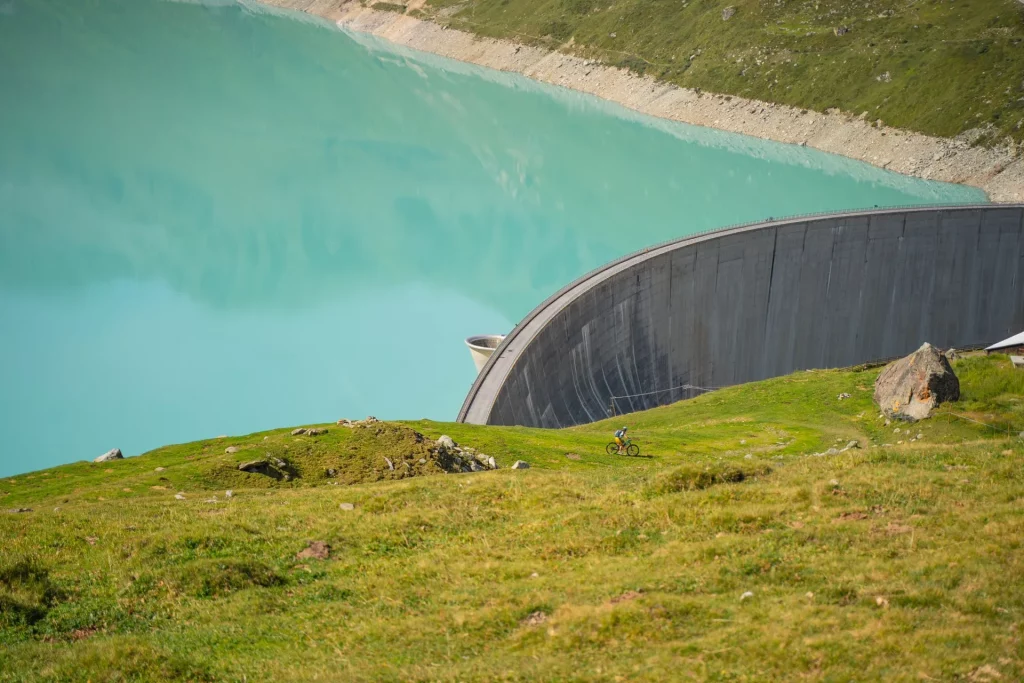 A cyclist descending down grassy slopes