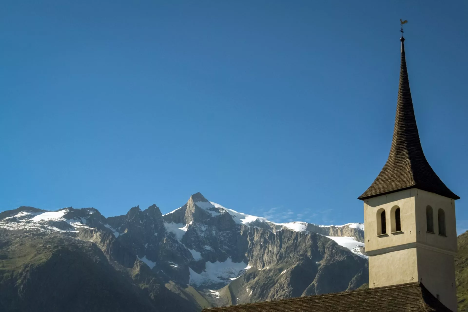 bellwald church and the mighty mountains behind